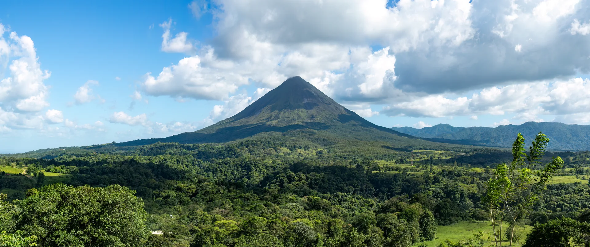 The near-perfect cone of Arenal Volcano rising above rainforest, Costa Rica